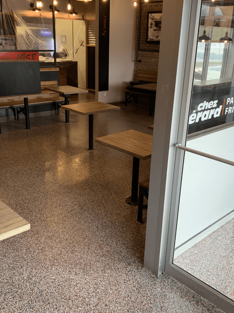 Commercial restaurant interior featuring epoxy flooring, showcasing a clean and professional appearance with durable surfaces, ideal for food service environments.