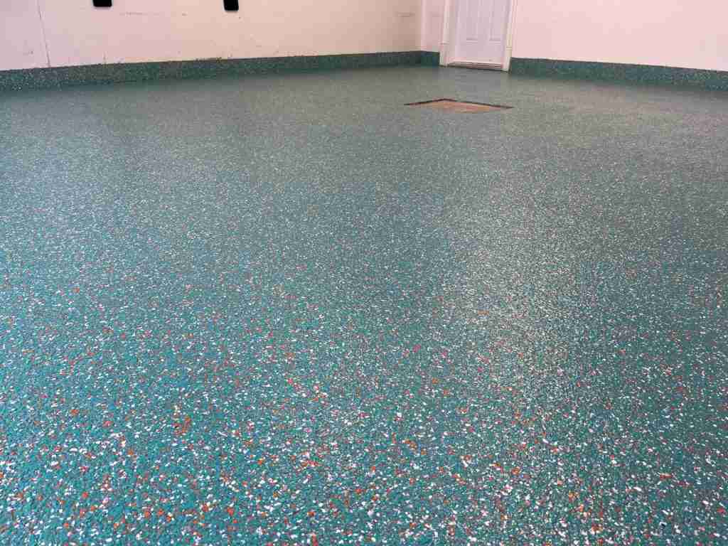 Turquoise flake epoxy floor in Westmount, installed by B&eacute;tonik